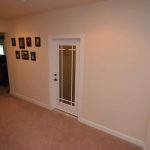 To see our rustic wine cellar design, you'll have to go through this tempered, frosted, white glass door.