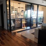 All the glass panels in this modern wine room are tempered to prevent condensation from happening.