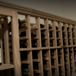 The team purposely built the racks up to a limited height only. The racks didn't touch the ceiling so the owner wouldn't have a hard time reaching the bottles.