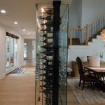 This custom wine wall is enclosed in glass on all four sides. This allows people to see the collection wherever they are standing.