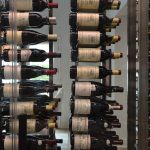 Because of the density of the wine bottles and the size of the wine racking, the collection in this wine wall looks like it's floating.