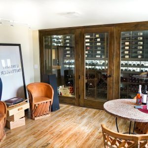 17 - This transitional style residential wine cellar mixes wooden and glass elements.