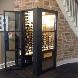 7 - Framed glass doors and walls protect and showcase the wine bottles in this gorgeous, modern home wine cellar. Conversion Project Contemporary Wine Cellar Under Staircase
