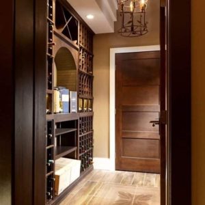 9 - This home wine cellar was designed to perfectly match the style of this luxurious home. Wine Cellar Custom-Made by Expert Interior Designer