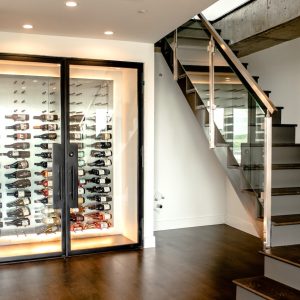 37 - This modern glass wine closet uses peg racking to hold and showcase the wine bottles.
