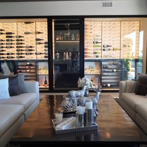 15 - The LED backpanels in this modern home wine cellar highlight the bottles and look amazing. Living Room Wine Cellar