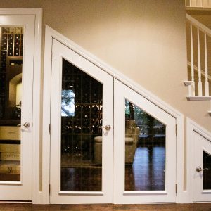 10 - Wine cellar styles are as diverse as their owners. What do you think of the doors on this under-the-stairs wine cellar? Small Custom Wine Cellar Below Stairs