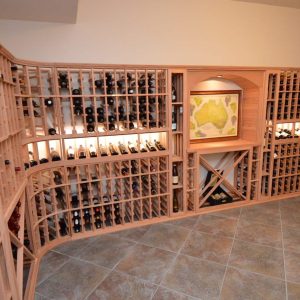 24 - This custom wooden wine racking includes a decorative arch and tasting nook.