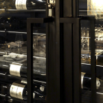 This modern wine display is secured by a traditional lock and key system. Large door handles allow users to open the glass enclosure. Modern Wine Cellar Door Handles