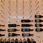 Brushed chrome pegs were installed one by one to hold the wine collection.