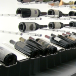 Metal high reveal racks present bottles in a label-forward slanting position. They can be in either big or small wine cellars.