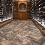 Together with our custom wine wall design, herringbone tiles enhanced this wine cellar's signature look.