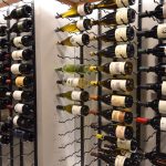 The modern section of our wine wall design is clad with custom W-series racks from VintageView.