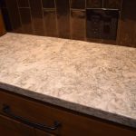 For a touch of elegance, we added a marble countertop within our wooden wine wall design.